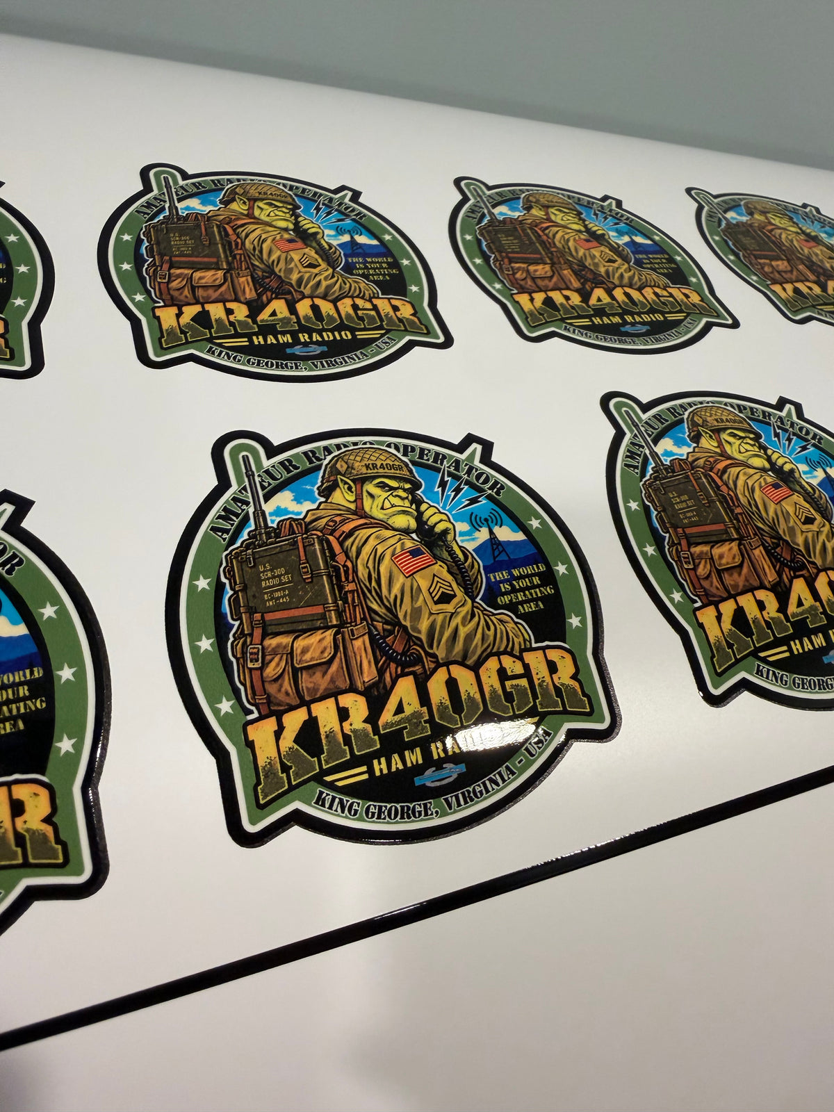 Sheet of KR4OGR ham radio stickers featuring a cartoon radio operator with a backpack radio.