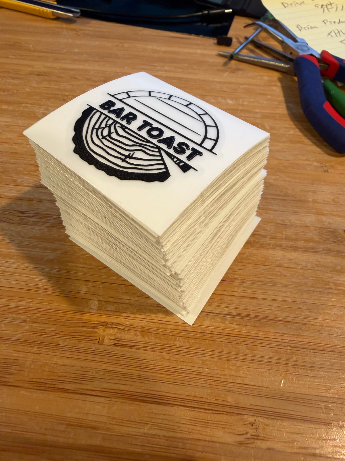 BAR TOAST logo decals printed on clear vinyl, stacked on white backing sheets.