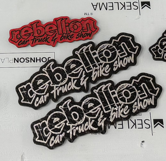 Three Rebellion logo laser-engraved patches: two black patches and one red patch.