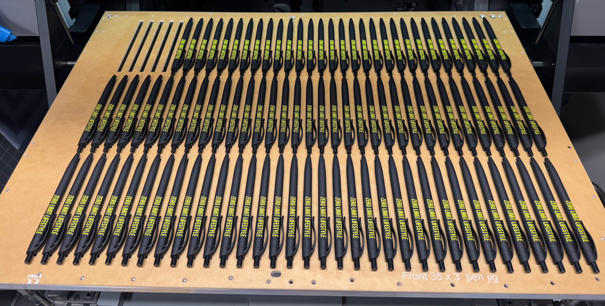 Batch of black pens with yellow Zero Limit Lifestyle printed branding.